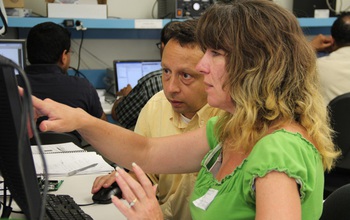 Woman and man working at a computer